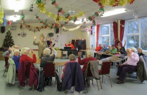Members of the Over 50's club warming up their vocal cords ahead of their Christmas Carol singing session.